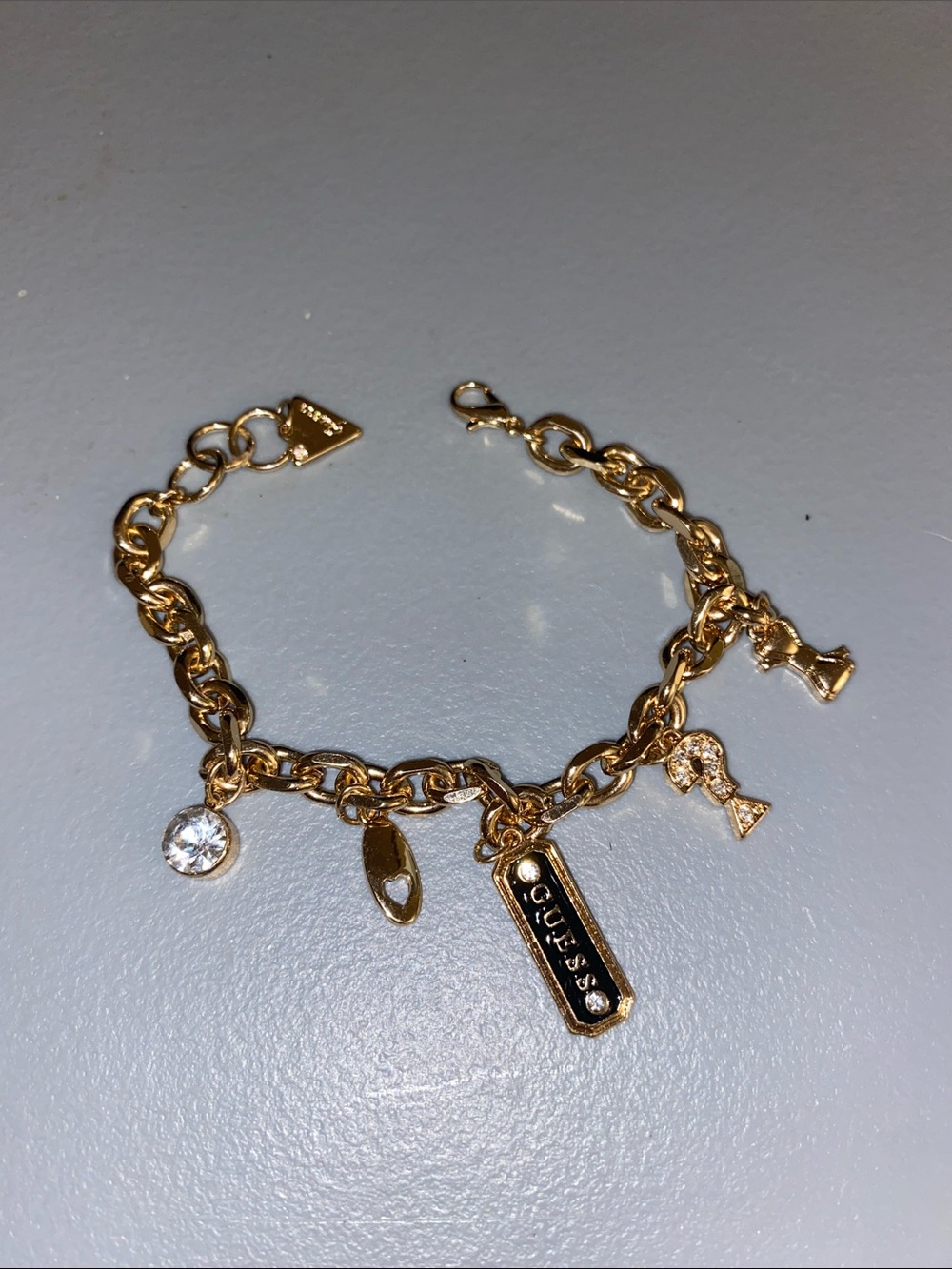 GUESS Gold Charm Bracelet with Crystal and Logo Tags